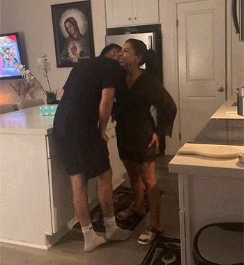  Happy couple laughing and sharing a playful moment in a cozy kitchen setting